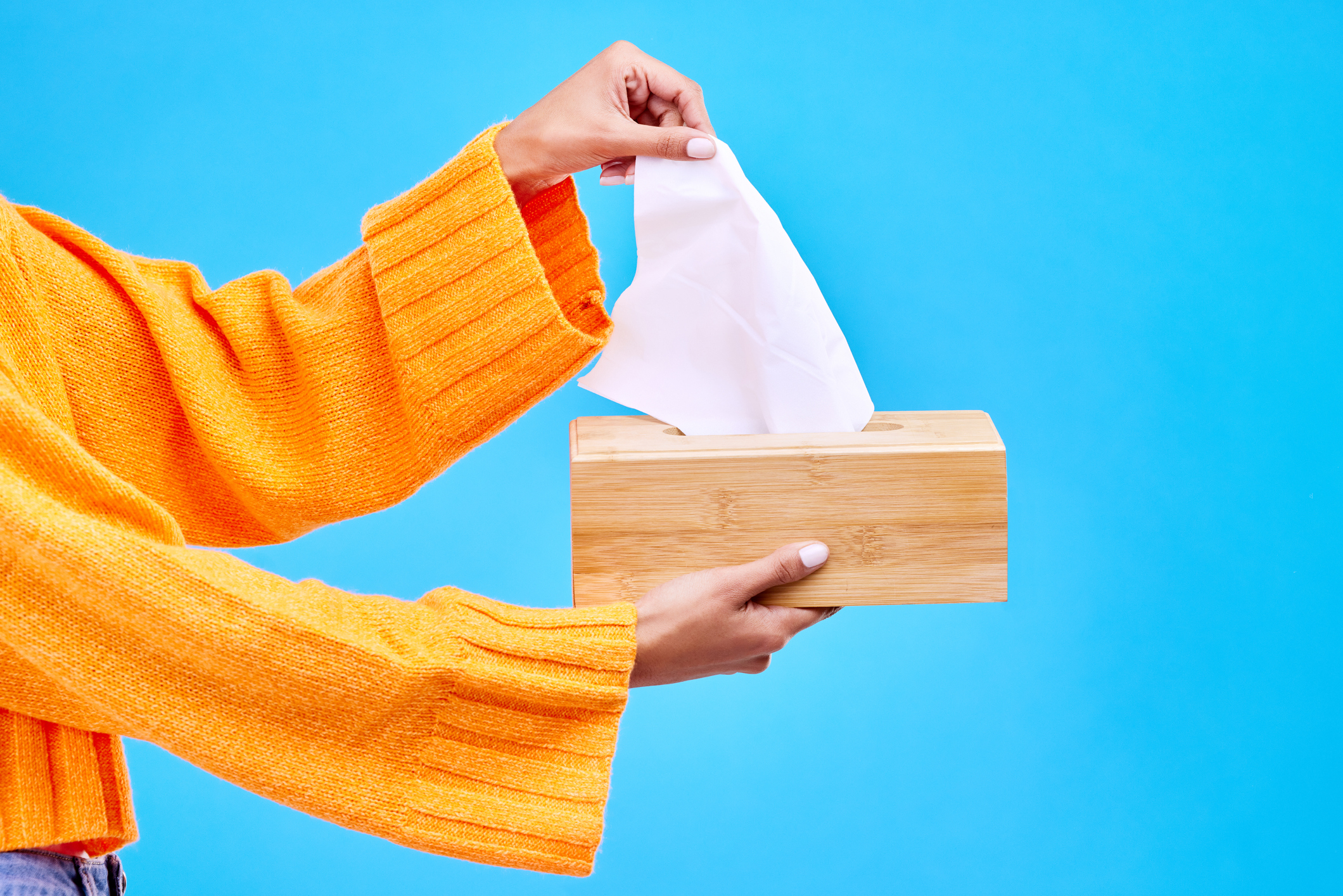Person pulling tissue from a box, possibly related to dealing with emotional moments in relationships