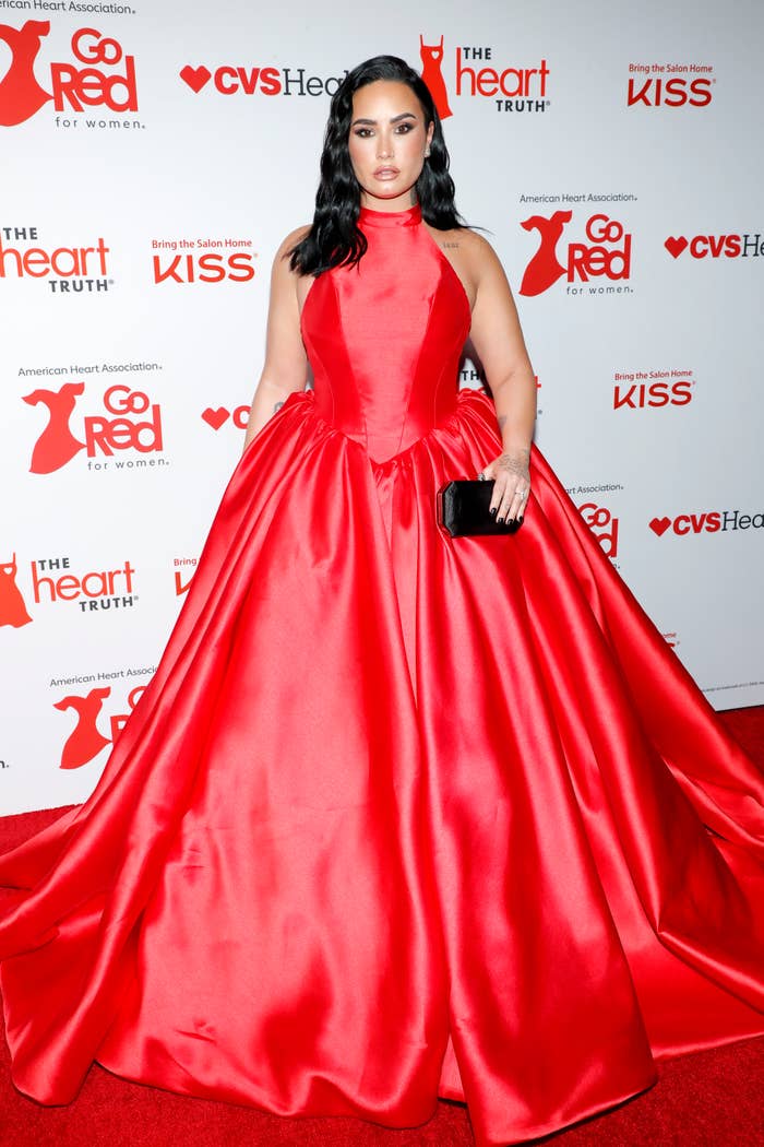 demi wearing a large ball gown on the red carpet for the event