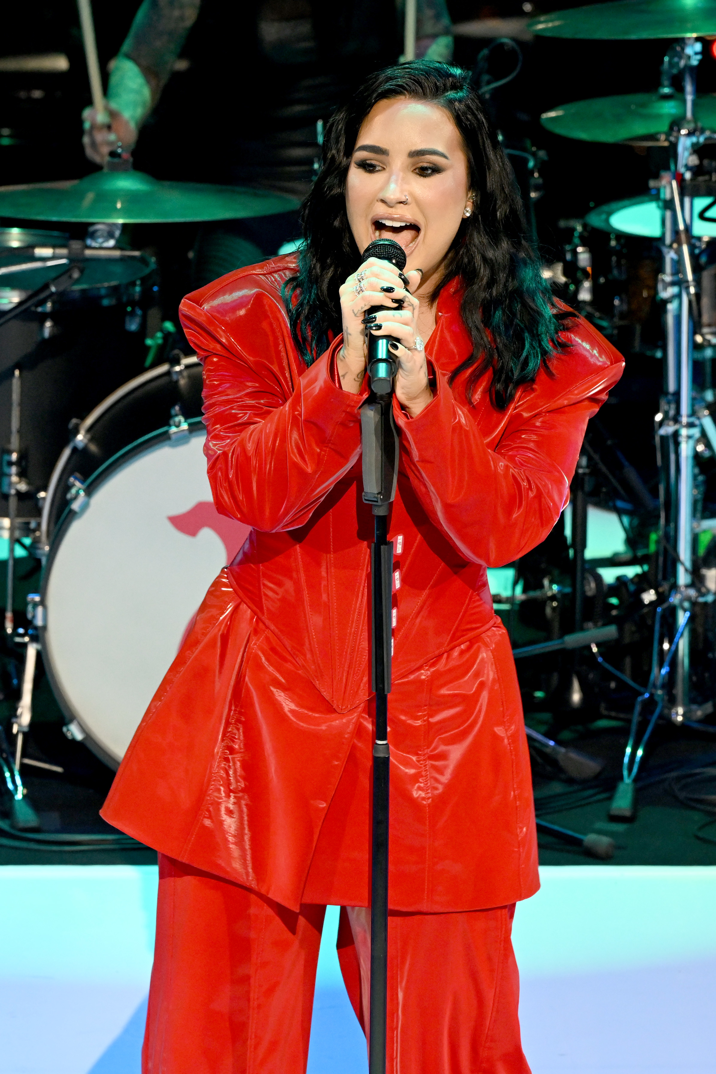 demi singing into a mic on the stand