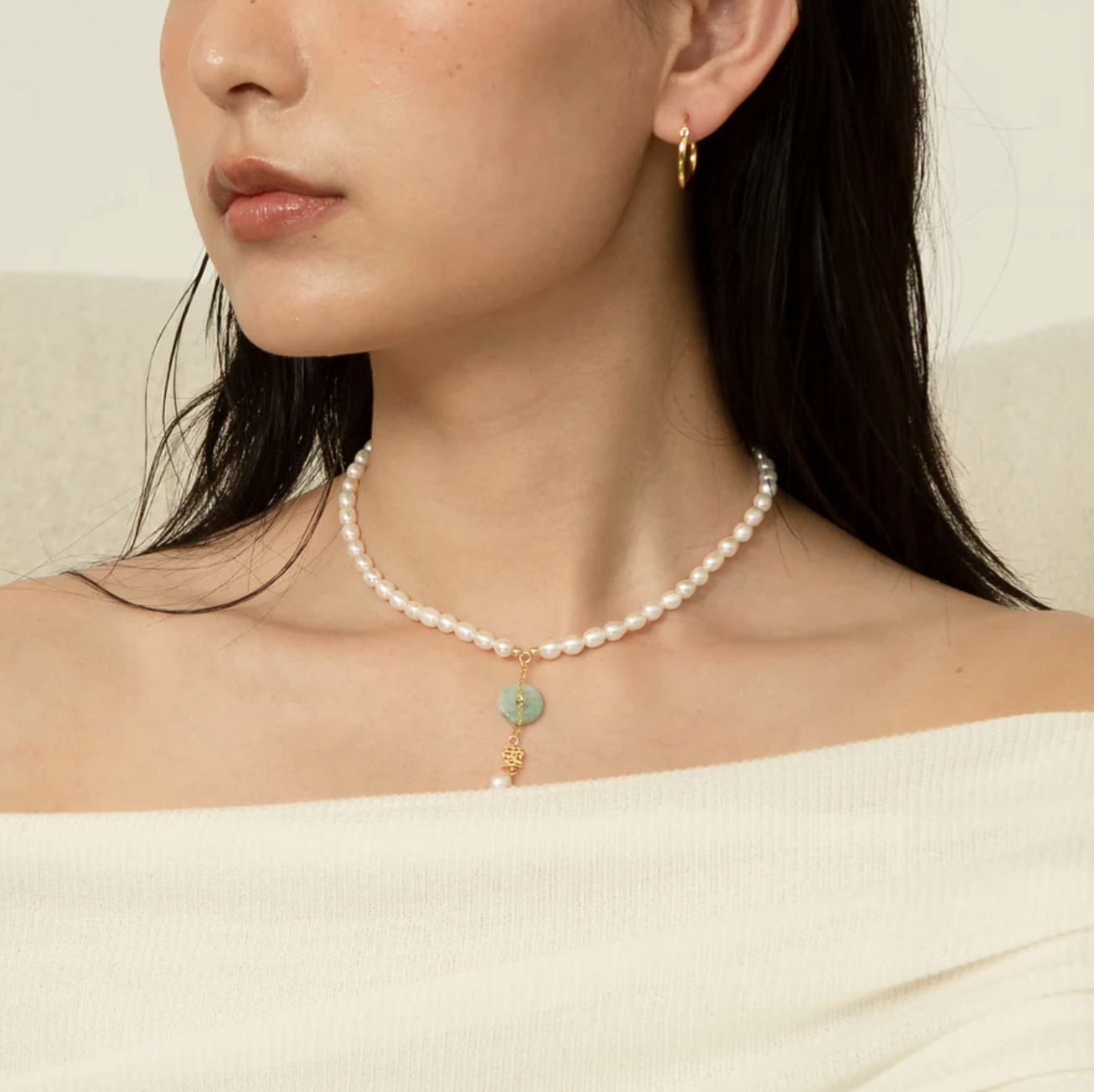 Model wearing jade pearl necklace