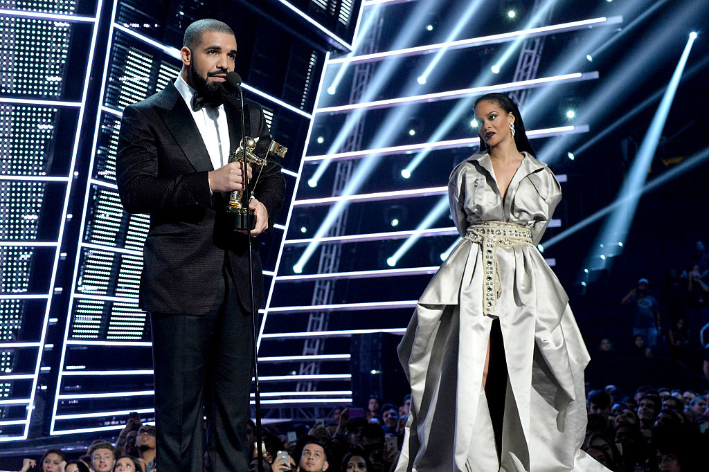 Drake presenting an award to Rihanna onstage