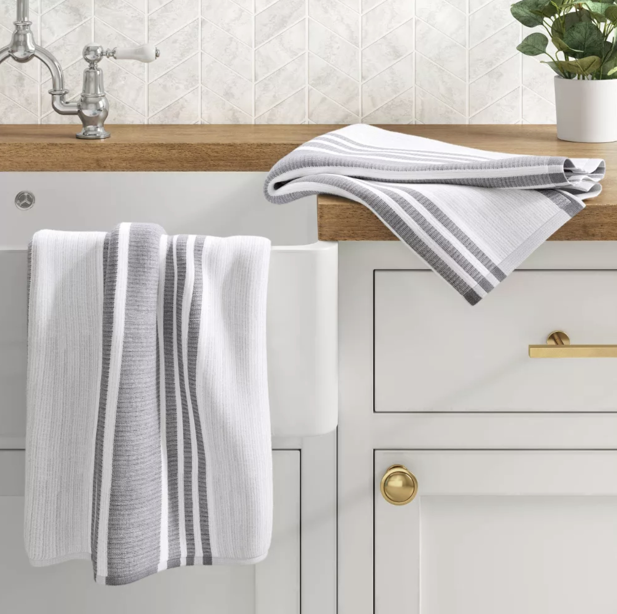 A set of grey and white kitchen towels