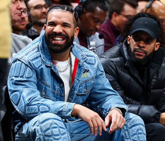 A closeup of Drake sitting at an event