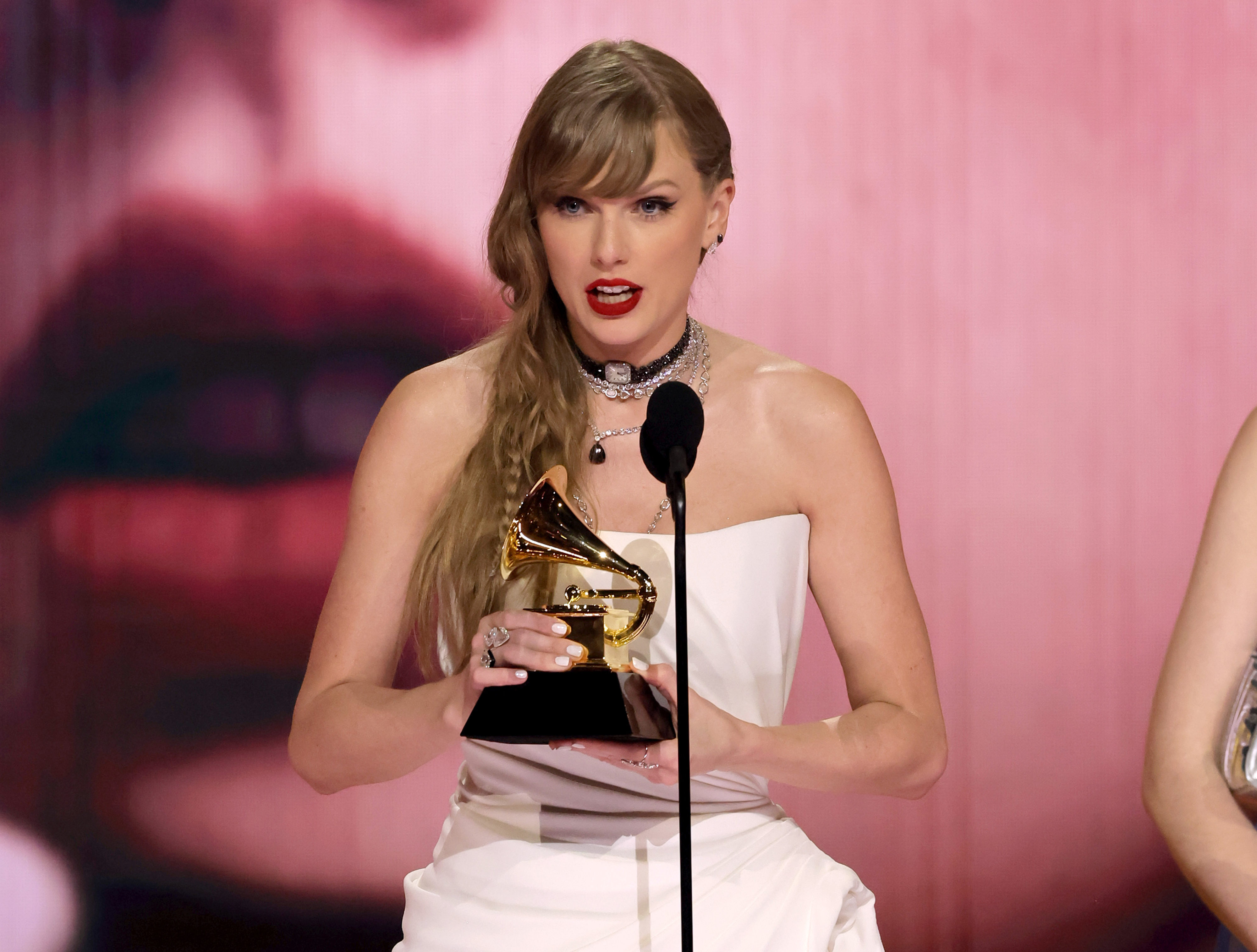 Close-up of Taylor onstage holding a Grammy