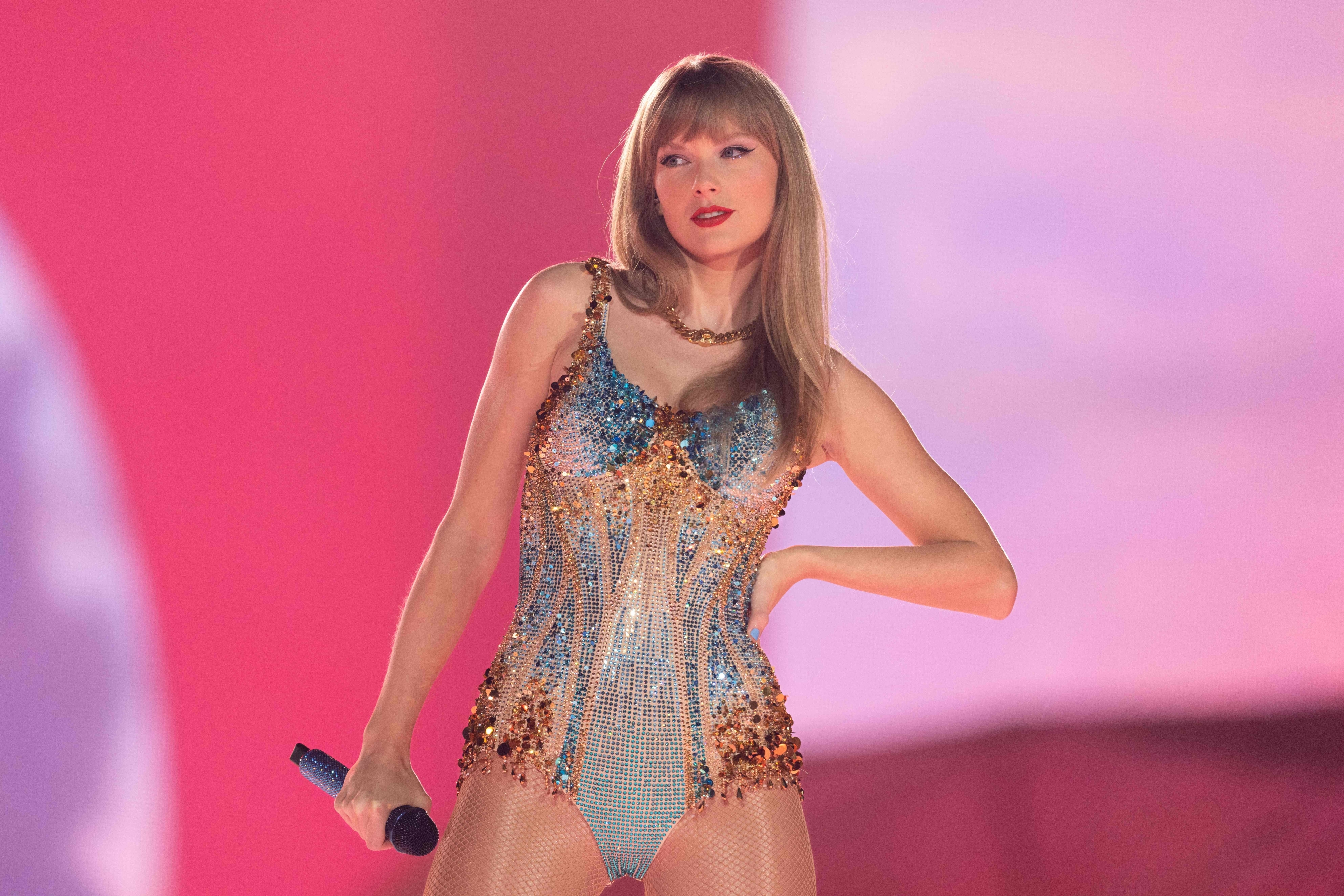 Close-up of Taylor onstage in a spangly bodysuit