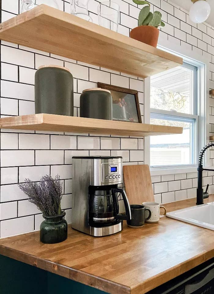 the silver and black coffee maker on a kitchen countertop