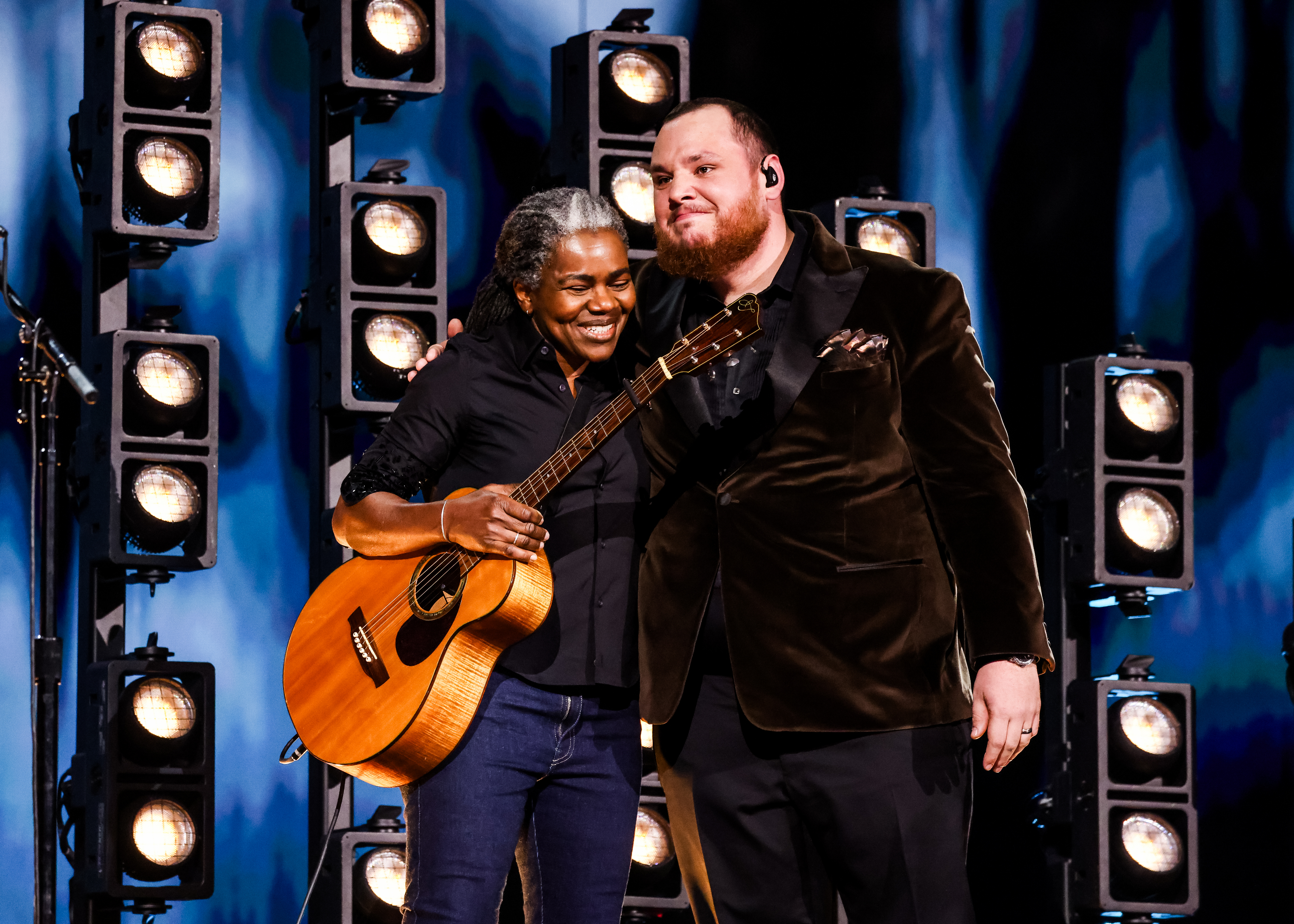 Tracy Chapman and Luke Combs hugging onstage