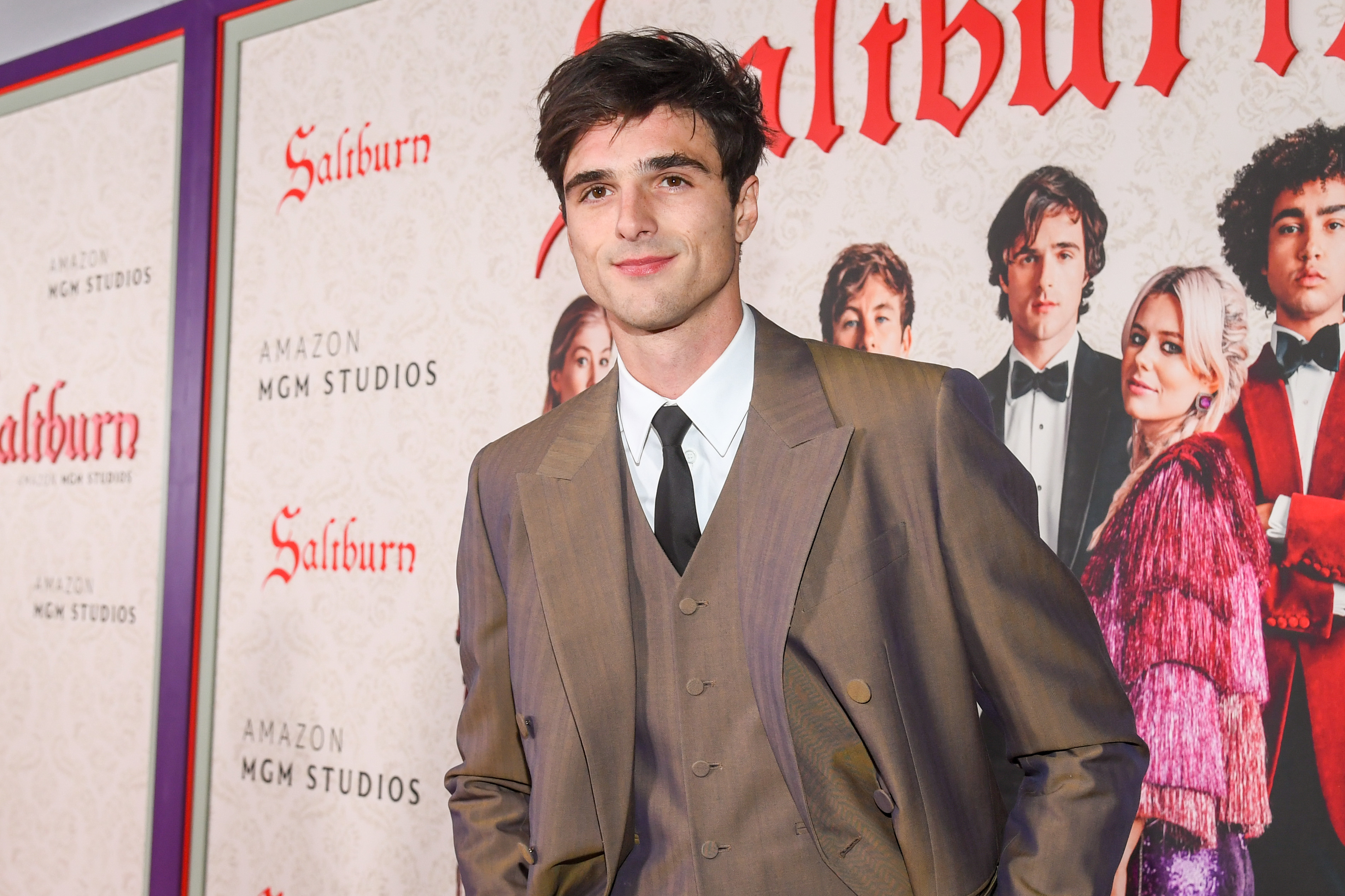 Close-up of Jacob in a suit, tie, and vest at a Saltburn event