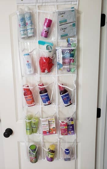 another reviewer showing organizer hanging on a bathroom closet door with toiletry items and medications