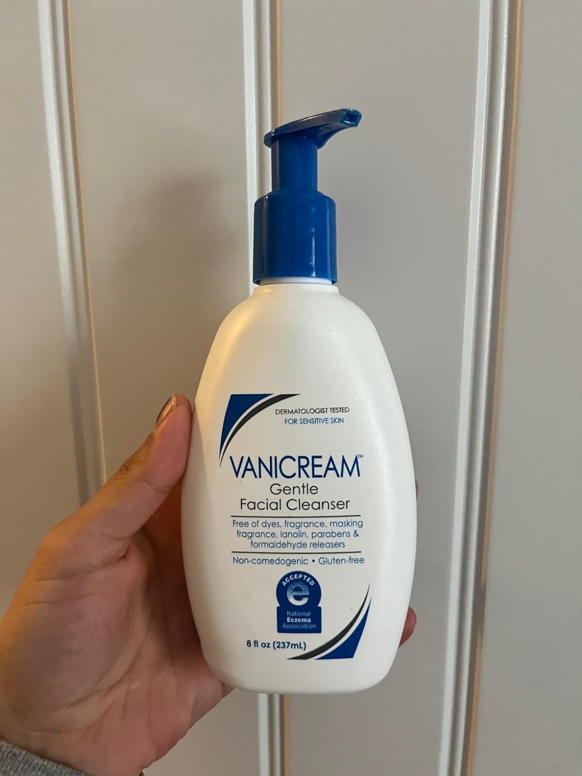 reviewer holding bottle of the Vanicream cleanser