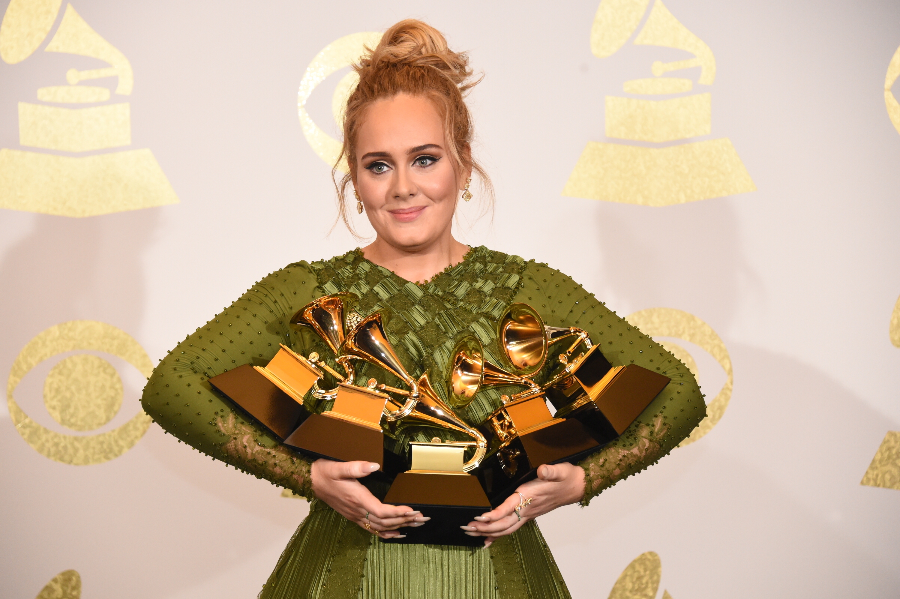 Adele with her four Grammys in her arms