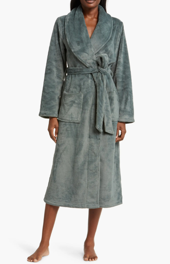 a model wearing the sage green robe