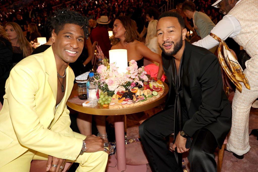 Jon Batiste and John Legend sitting at a table together