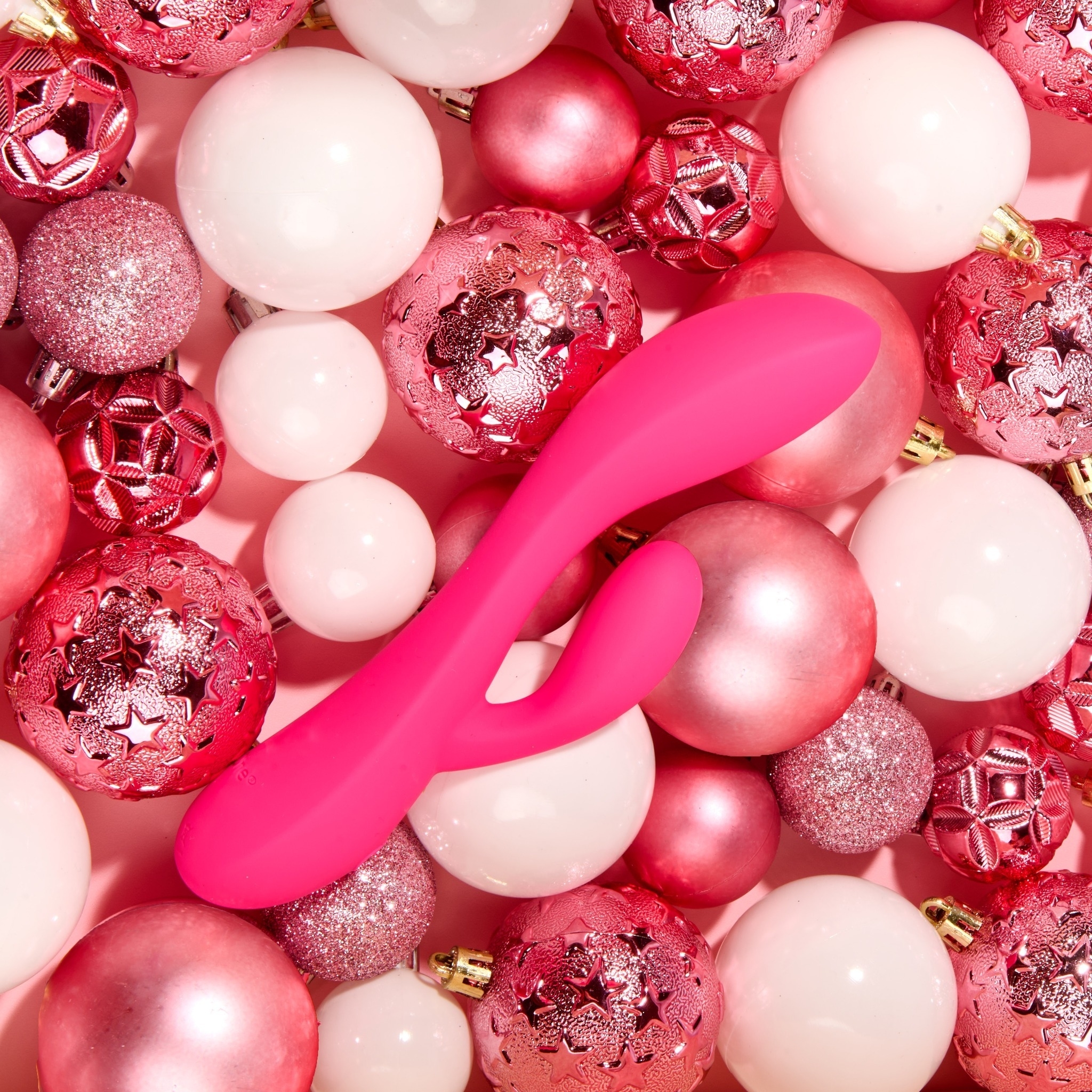 pink vibrator among pink and white baubles