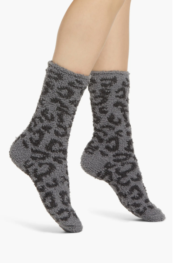 a model wearing the animal print fuzzy socks