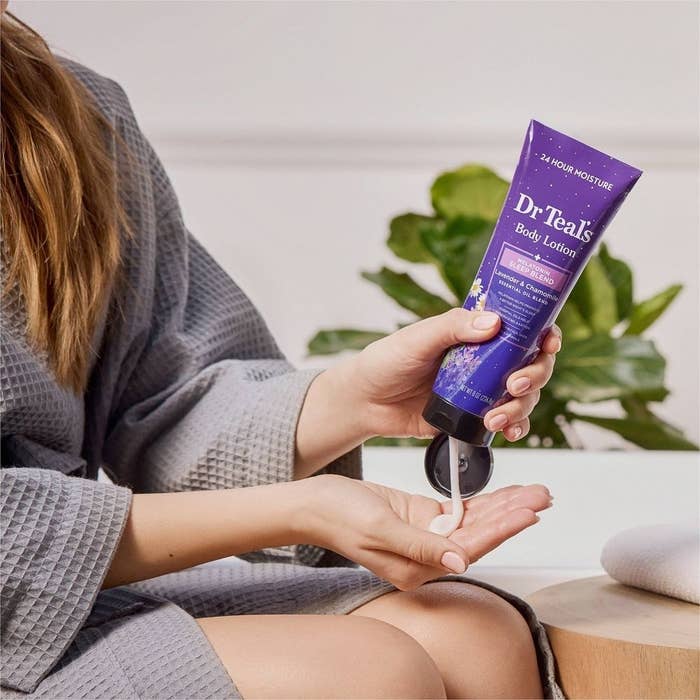 a model using he body lotion