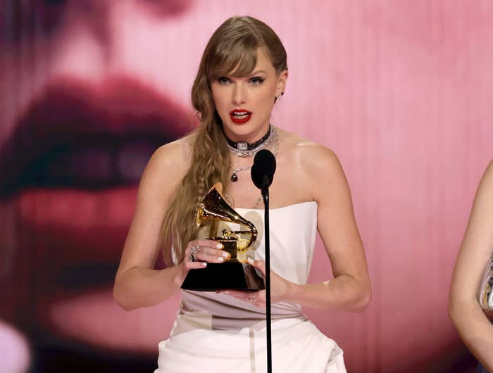 Close-up of Taylor holding a Grammy onstage