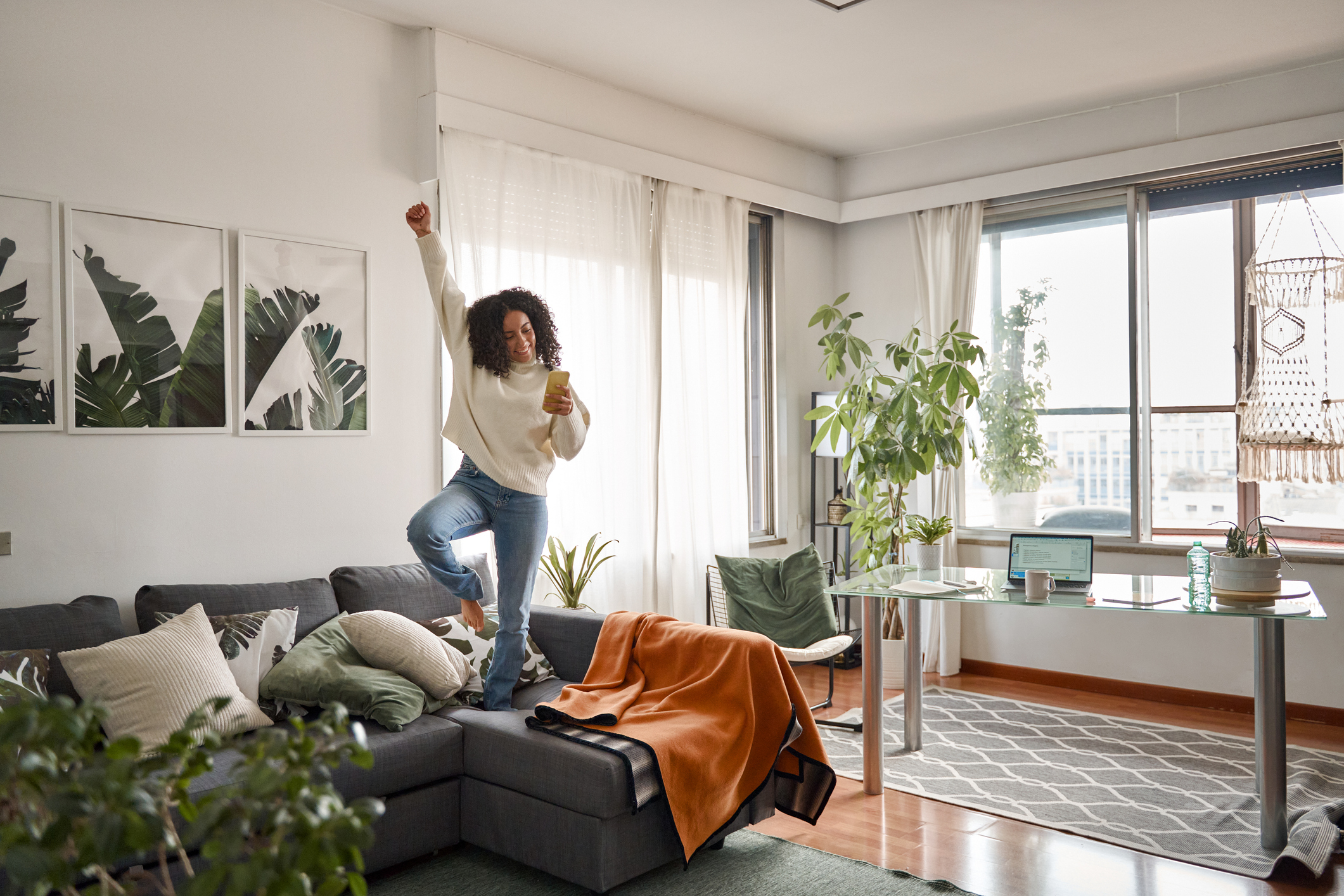 woman jumping on a couch