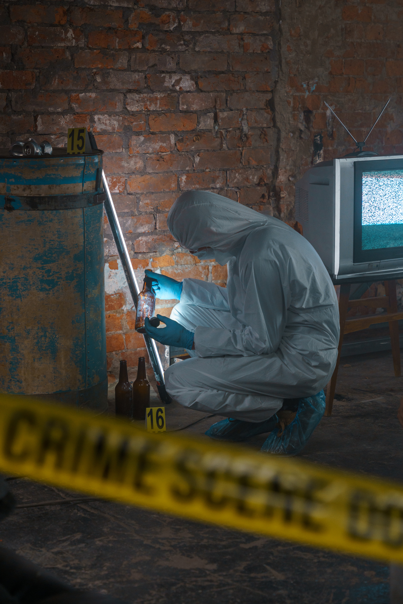 A person in a hazmat suit inspecting a crime scene
