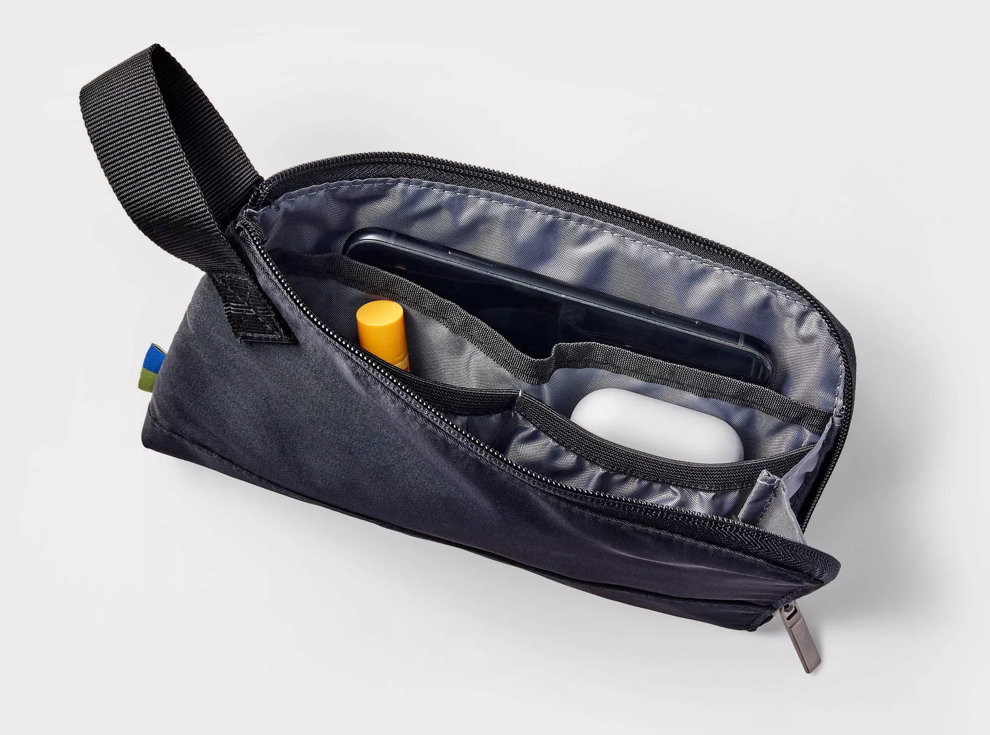 The black polyester fabric pouch with a single zippered compartment and multiple interior slip pockets