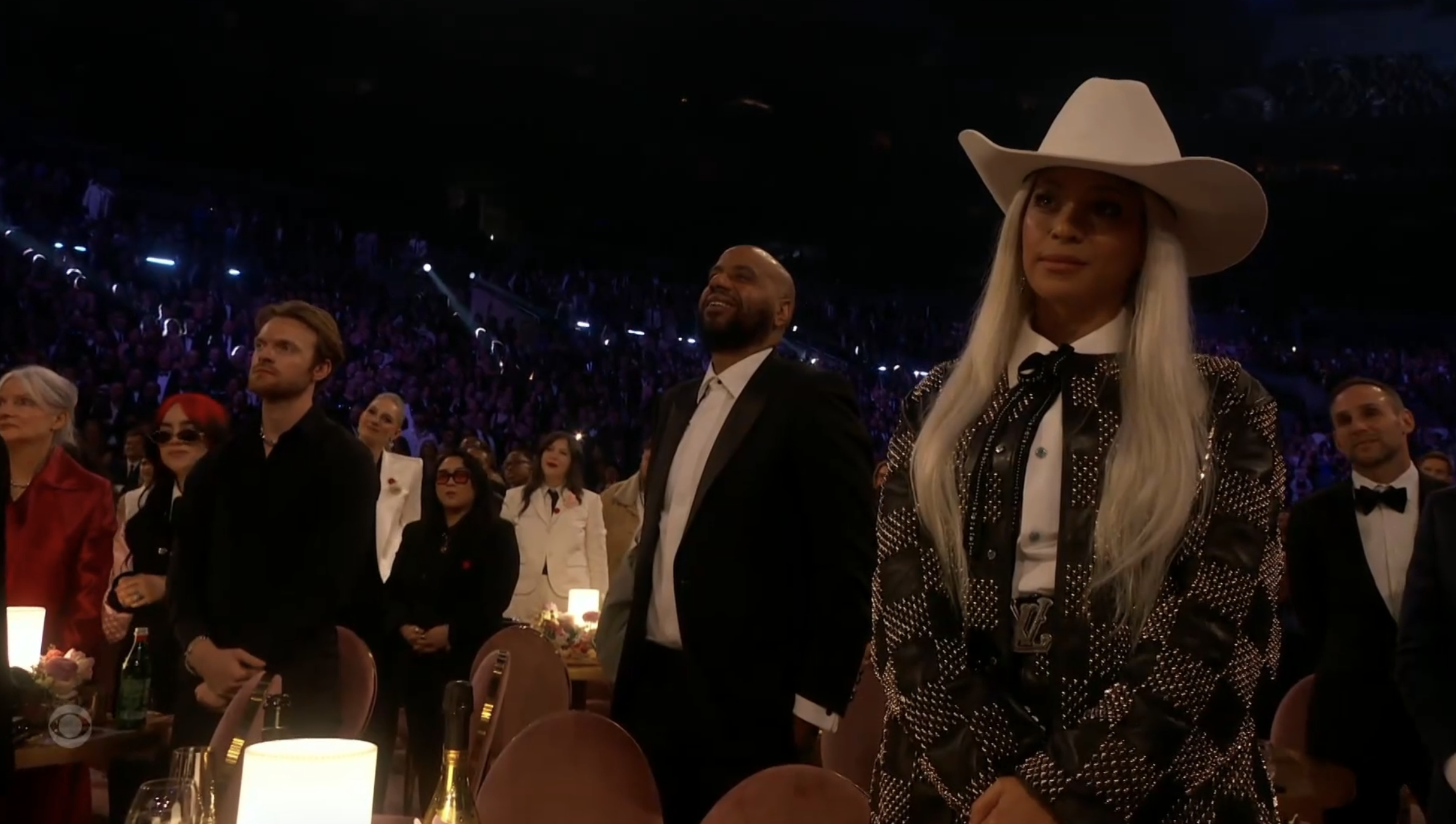 Beyoncé standing in the audience wearing a Western-style hat