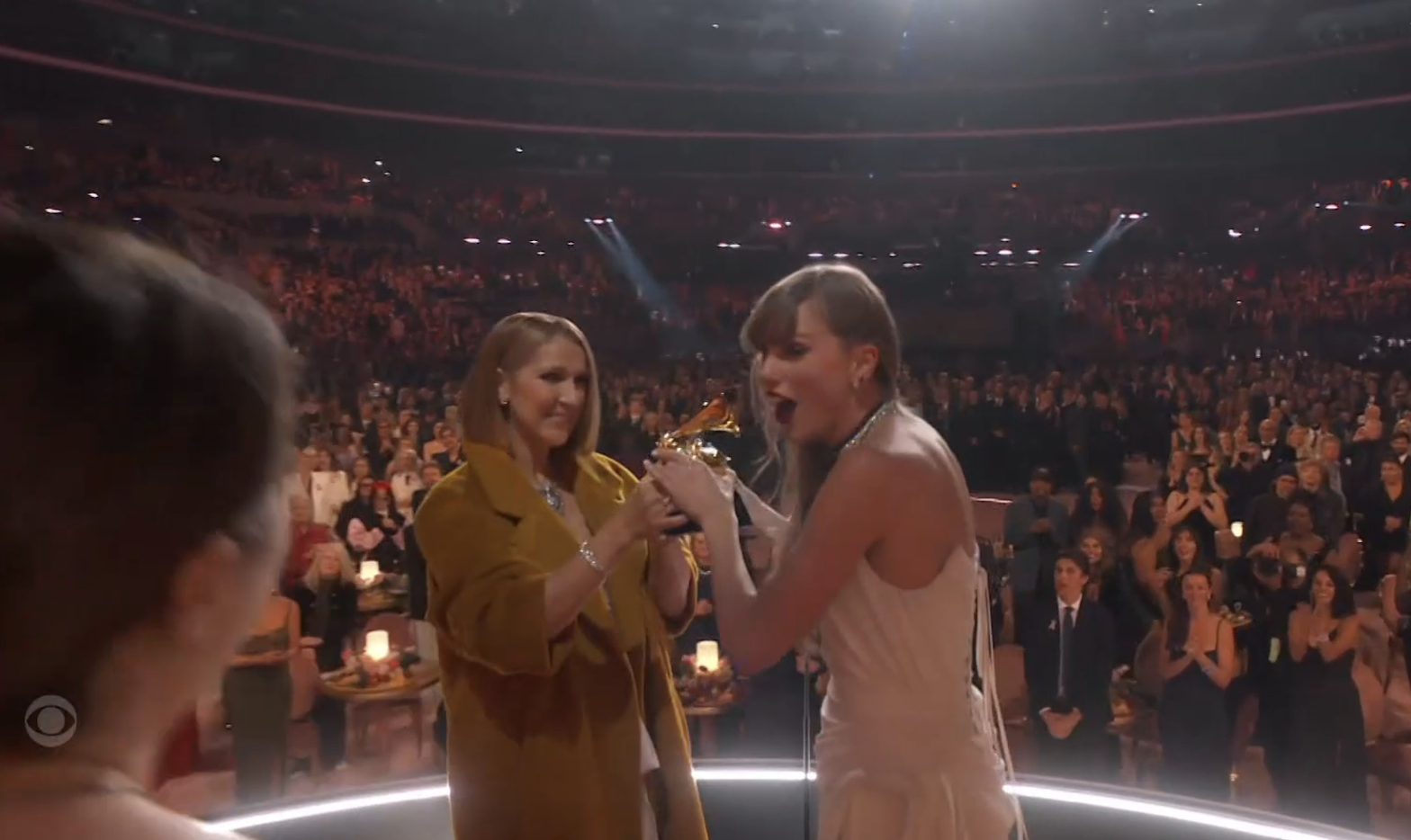 Close-up of Céline onstage with Taylor at the Grammys