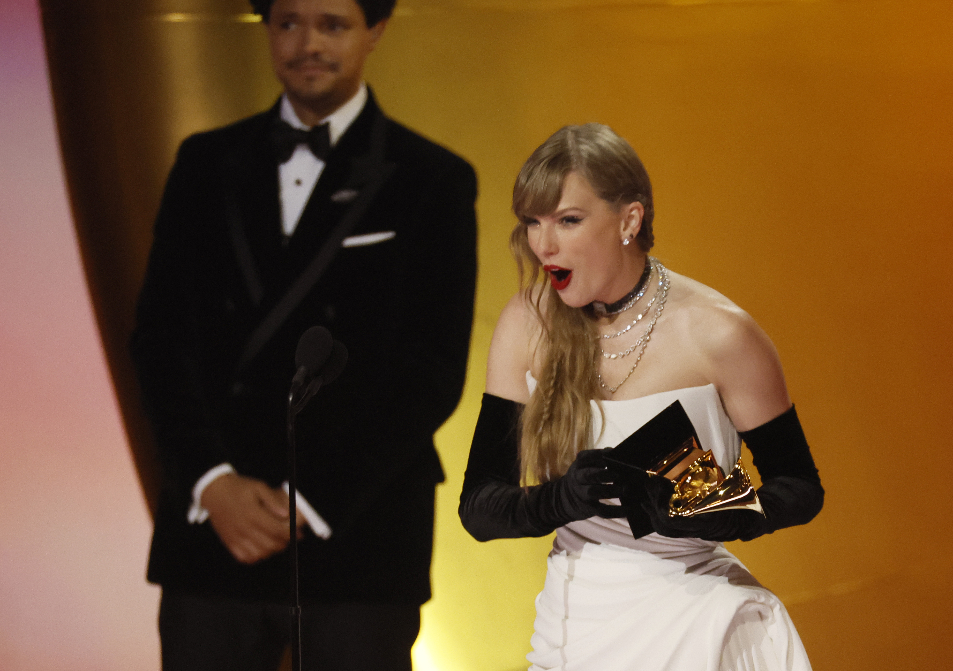 Taylor Swift onstage accepting her Grammy