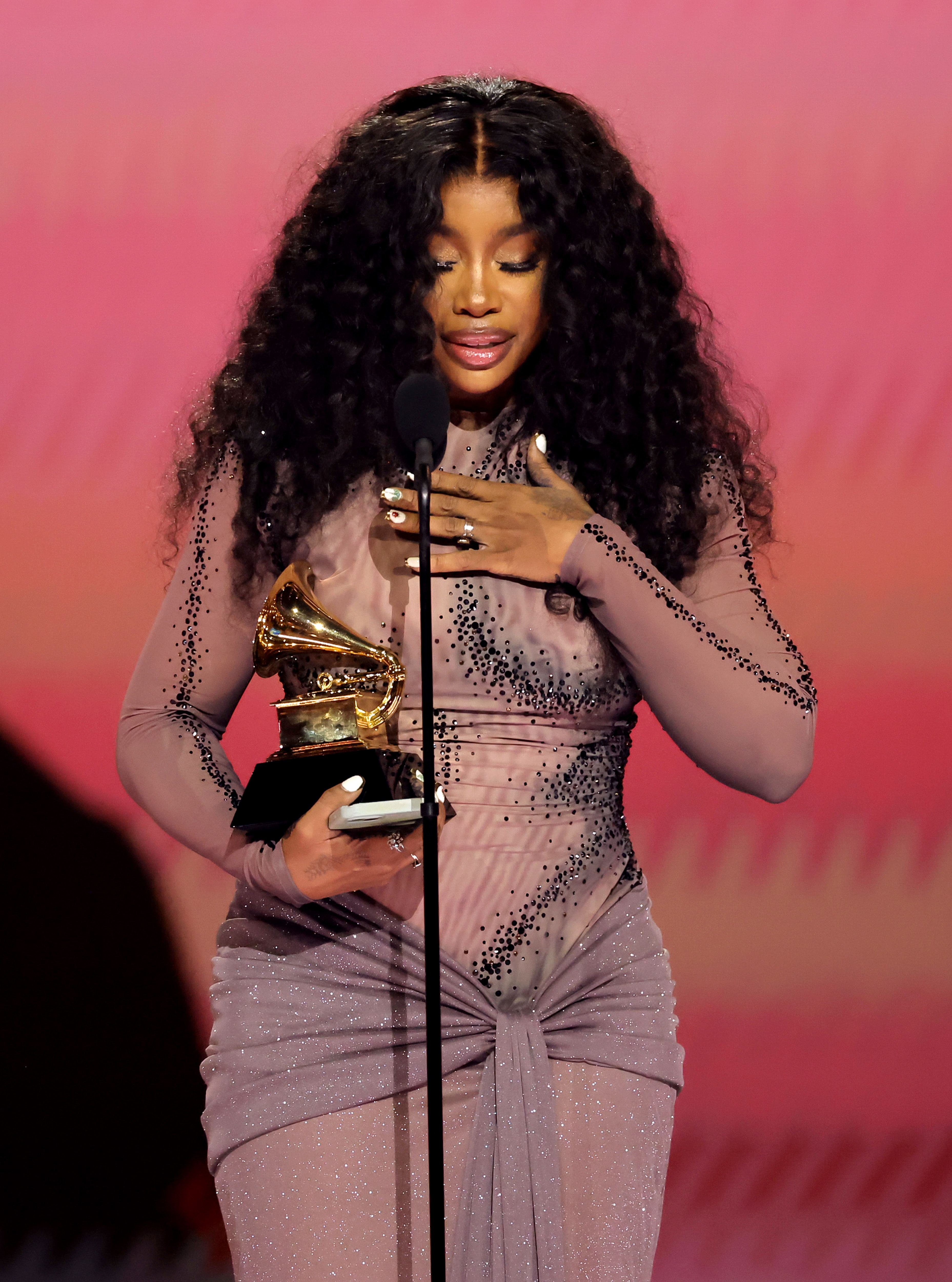 Closeup of SZA accepting her Grammy