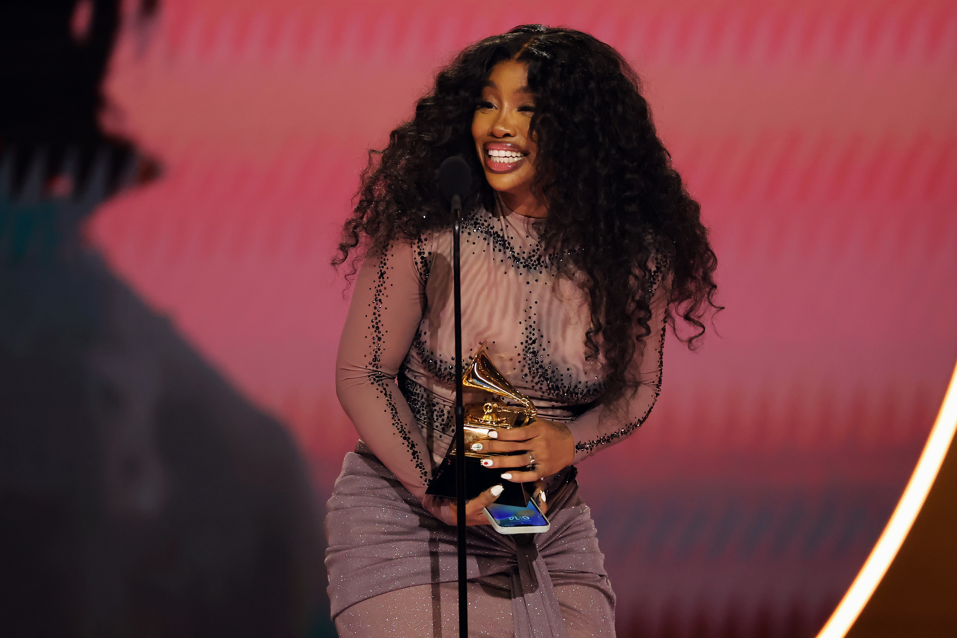 SZA accepting her Grammy award