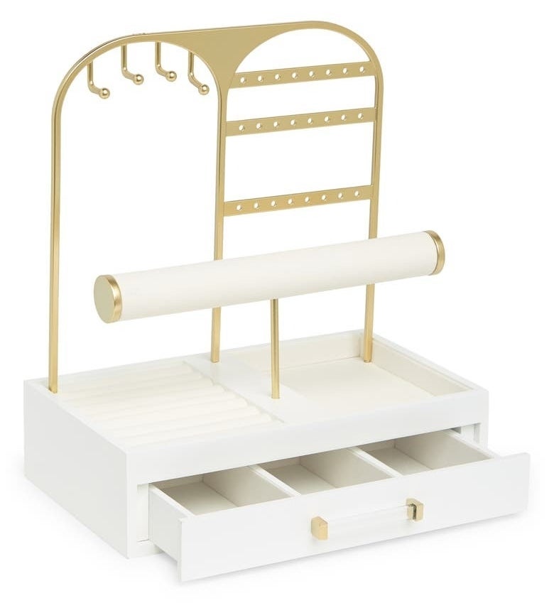 the white jewelry stand with gold accents