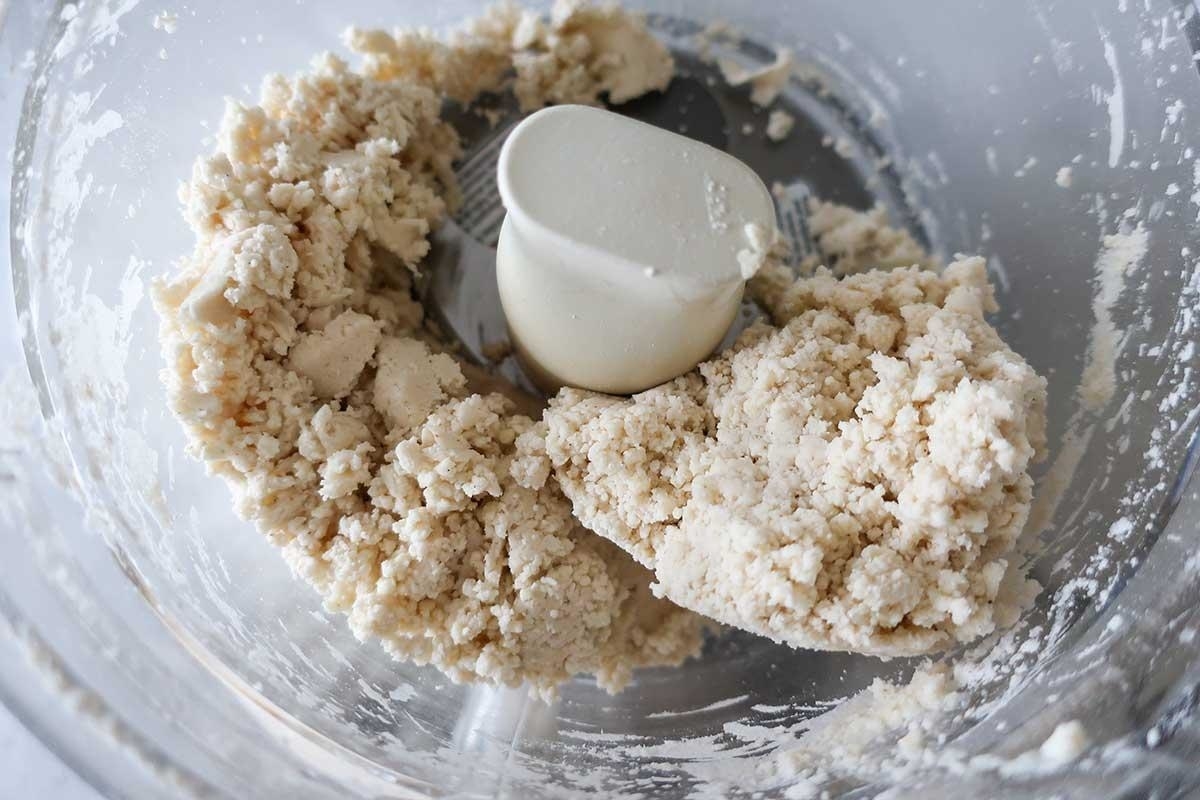 Piecrust dough being made in a food processor