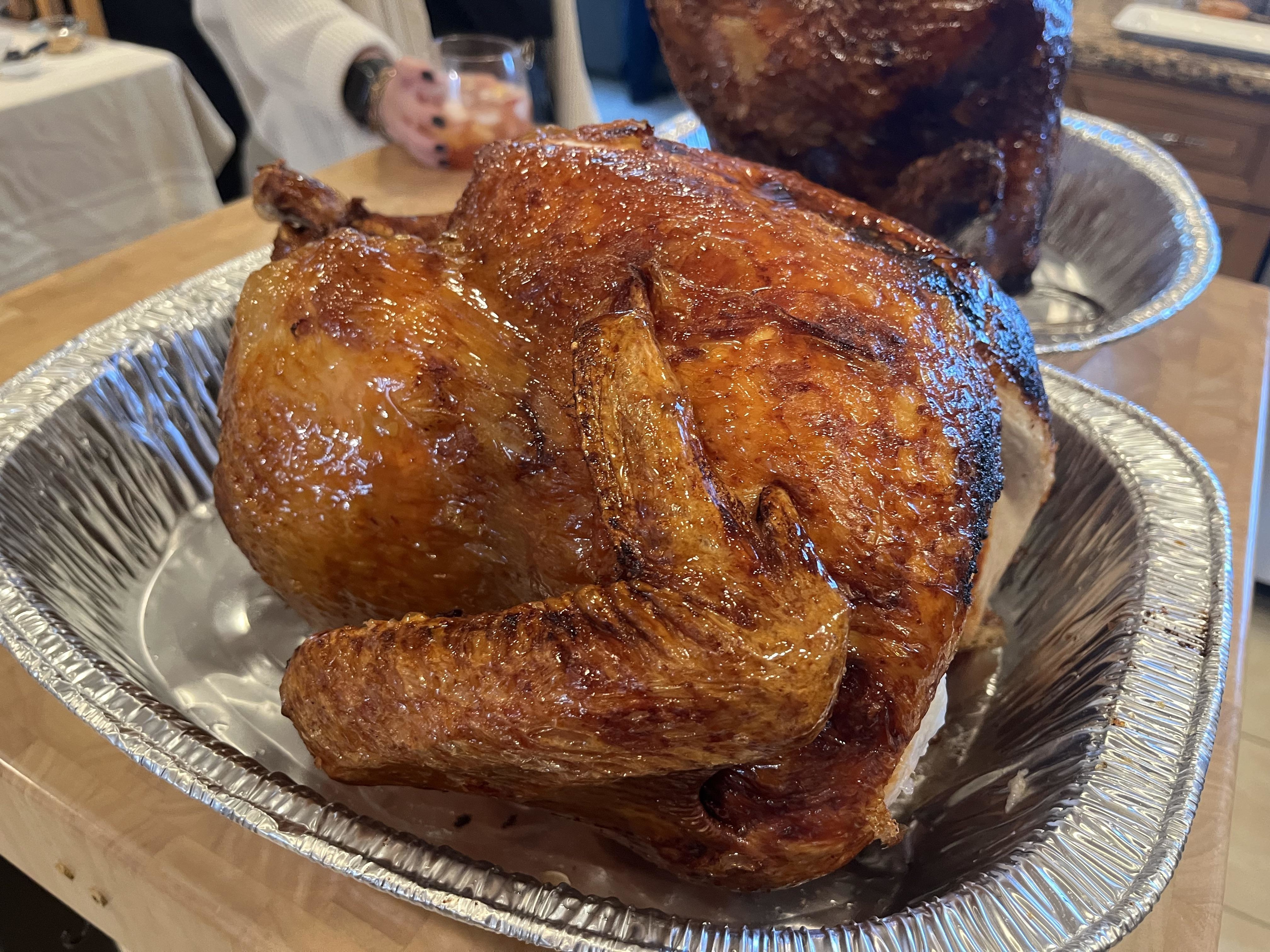A deep-fried turkey in a foil tray
