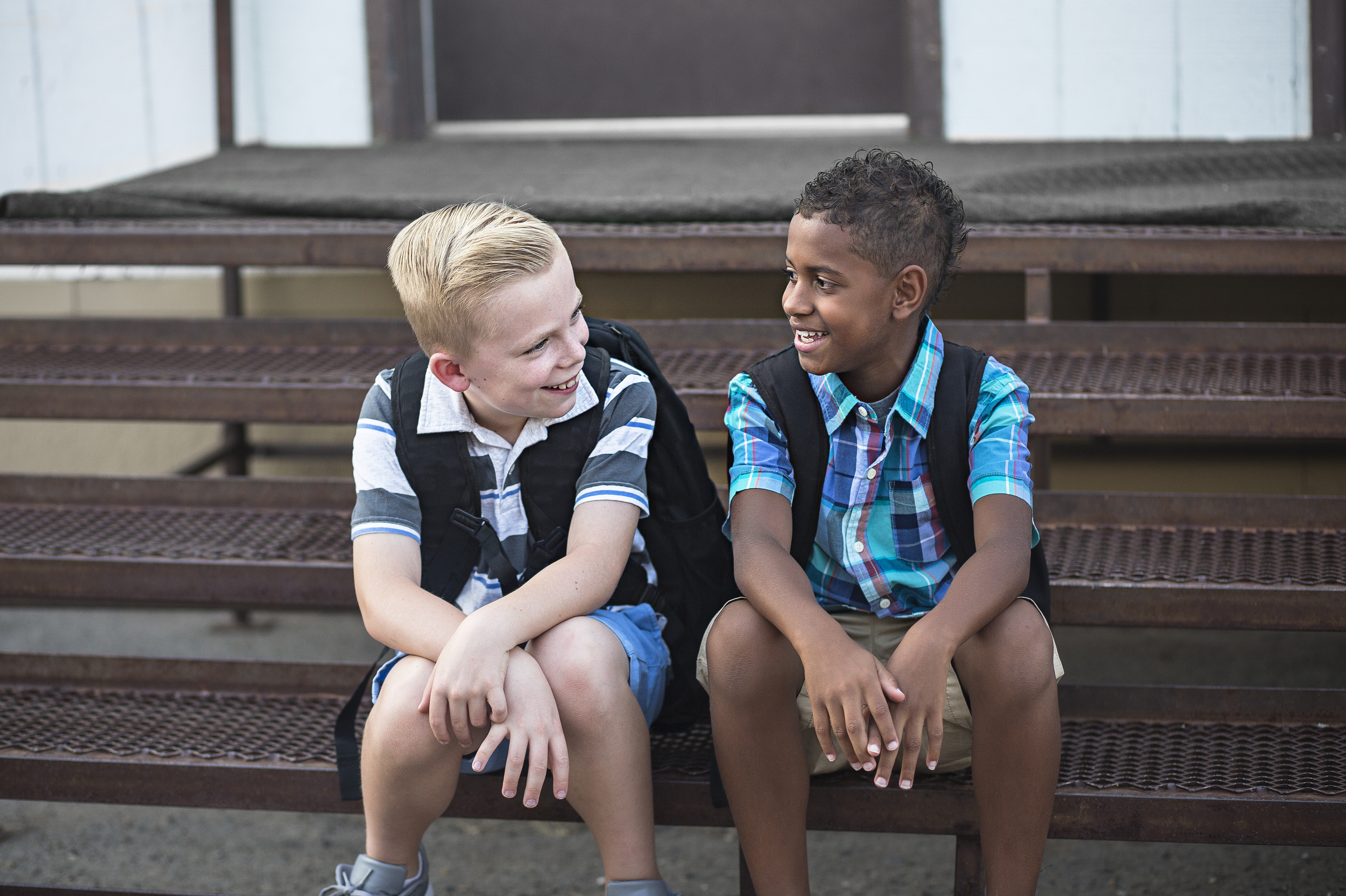 two young boys sitting and talking