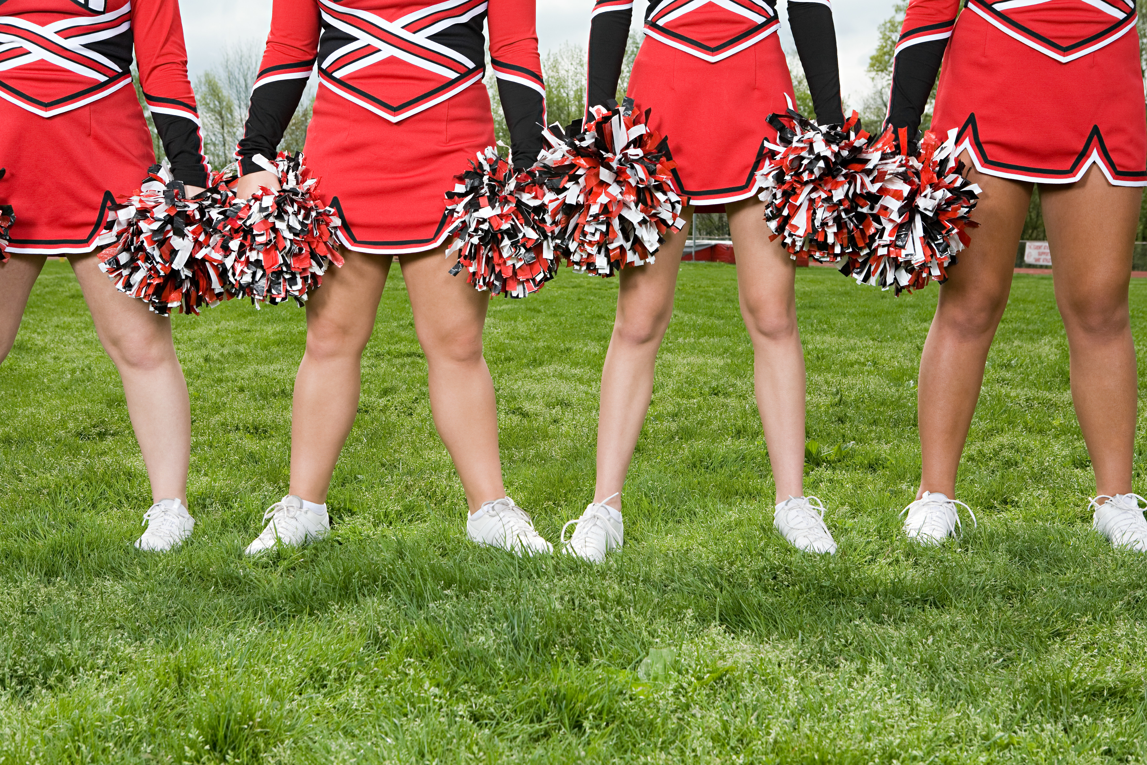 cheerleaders standing on a field
