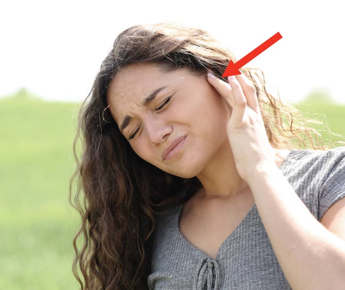 woman looks like she has an ear ache