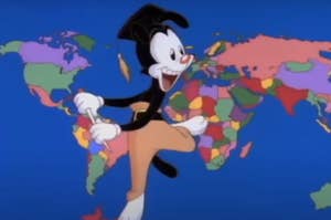 Yakko Warner from The Animaniacs standing in front of a world map