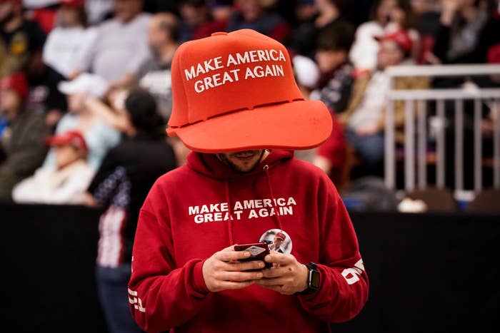 A supporter of U.S. President Donald Trump wears an oversize Make America Great Again hat