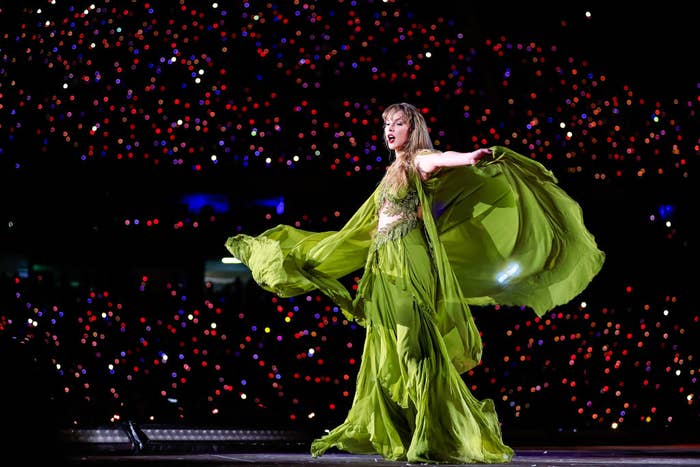 Taylor in a green dress on stage.