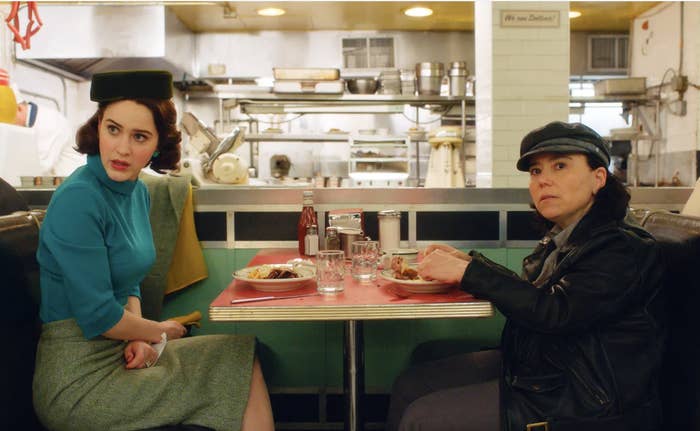 Two women sitting at a restaurant booth