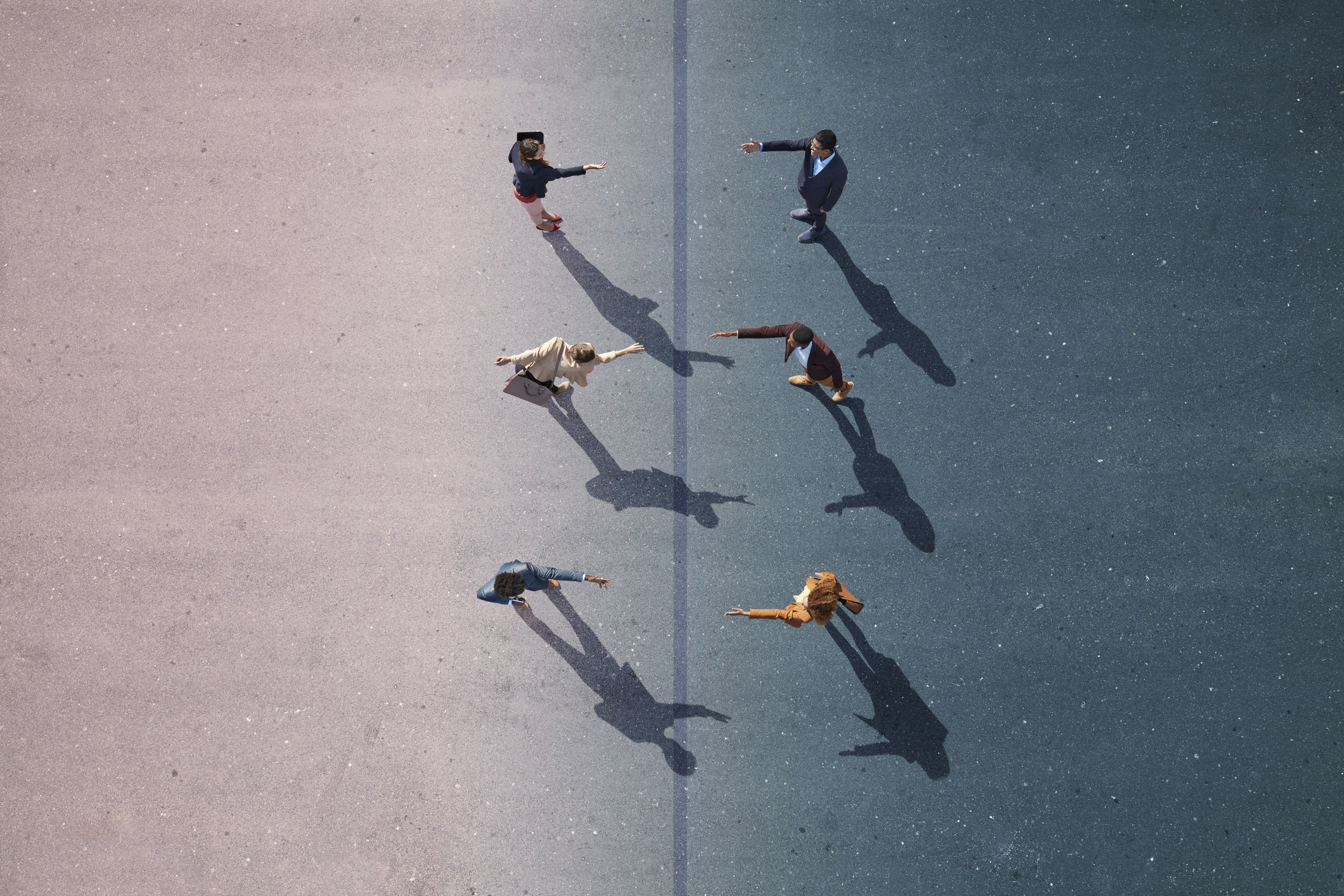 Group of young adults, photographed from above, on various painted tarmac surface, at sunrise