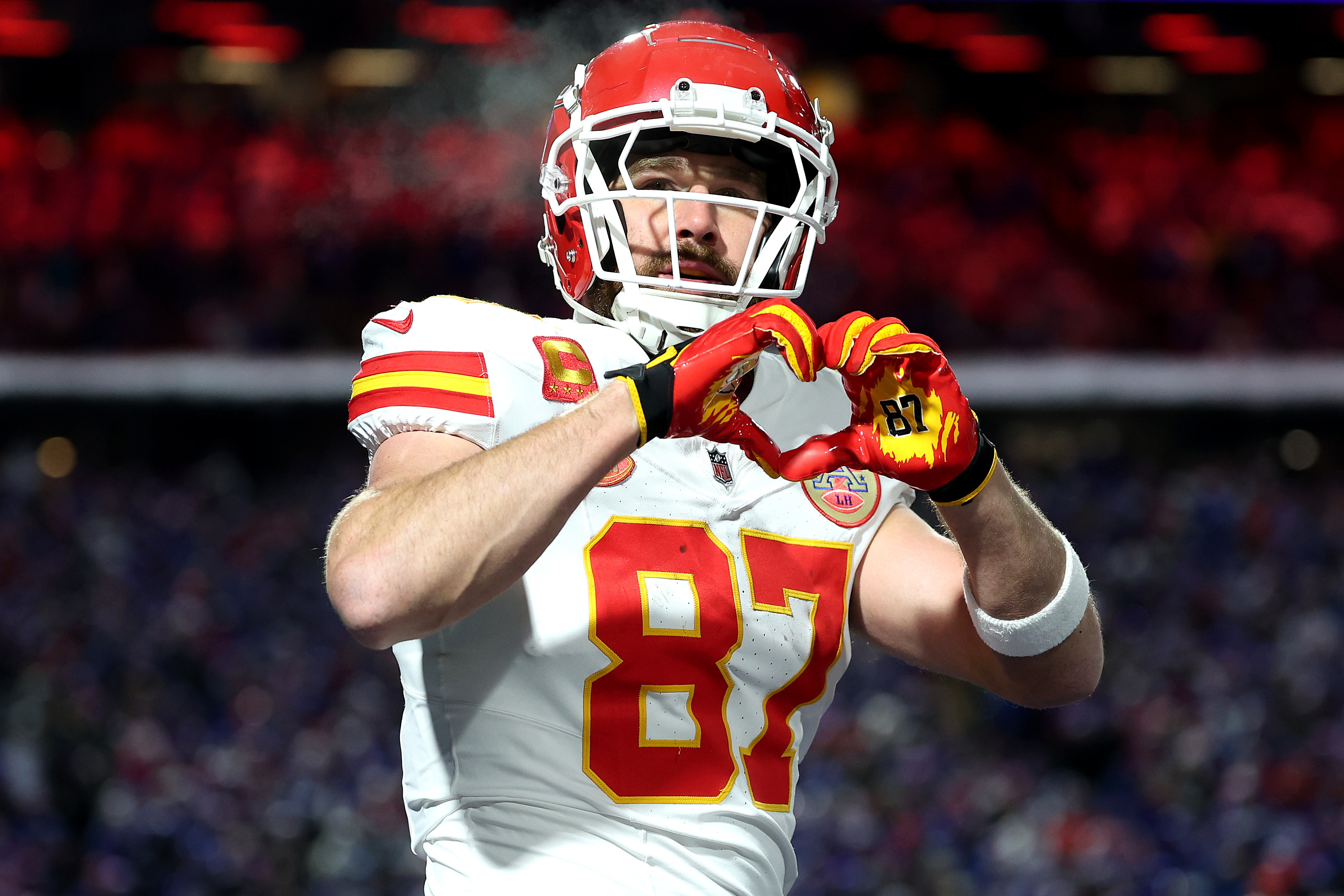 Closeup of Travis Kelce making a heart with his hands