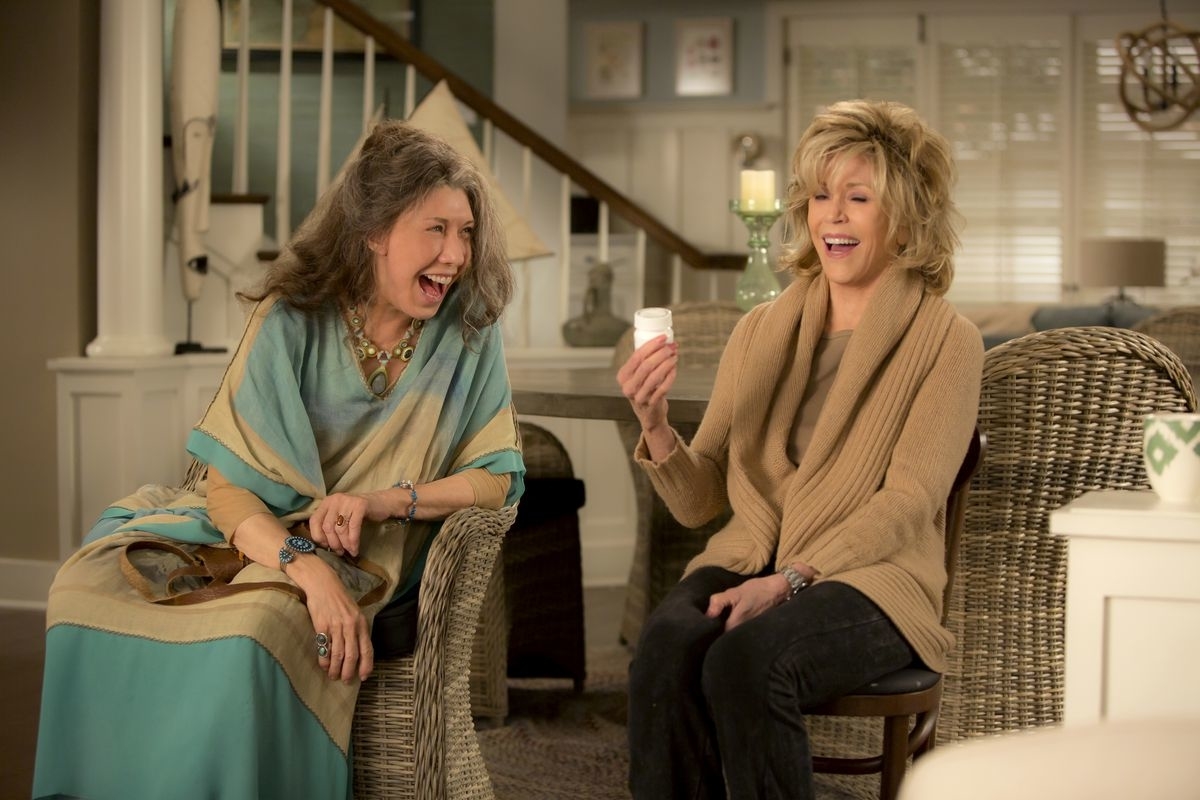Jane Fonda and Lily Tomlin laughing, sitting side by side