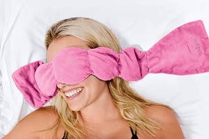 A model with the pink mask draped over their face
