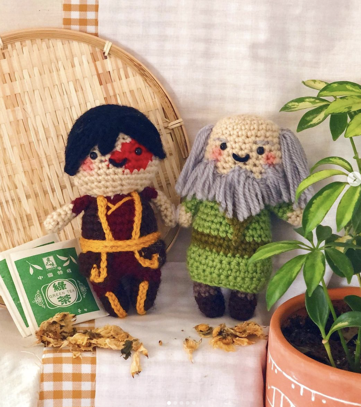 Zuko and Uncle Iroh inspired amigurumi plushies next to tea leaves