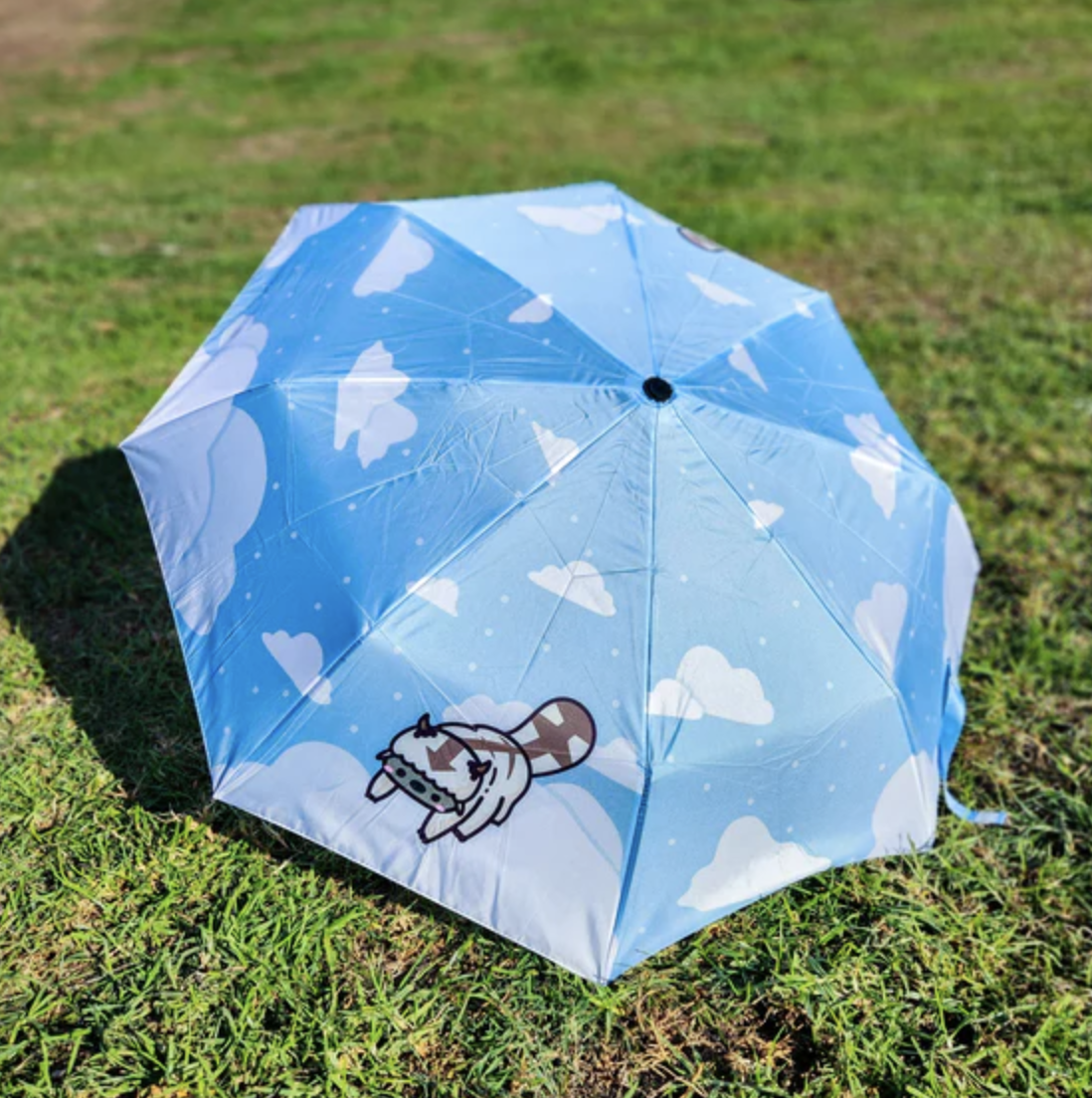 Blue umbrella featuring clouds and a chibi appa.