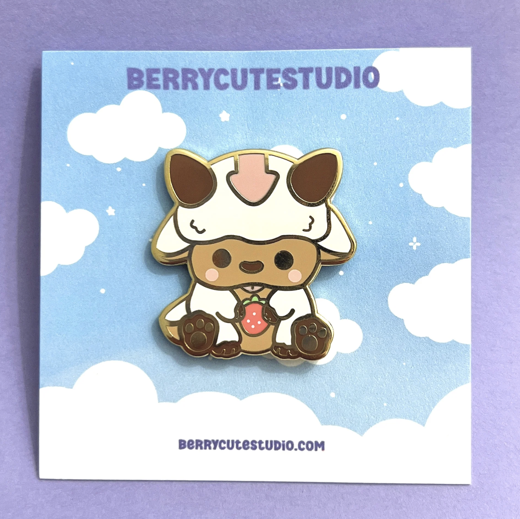 Enamel pin of Appa holding a strawberry
