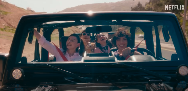 group of friends laughing in a jeep that has the top off