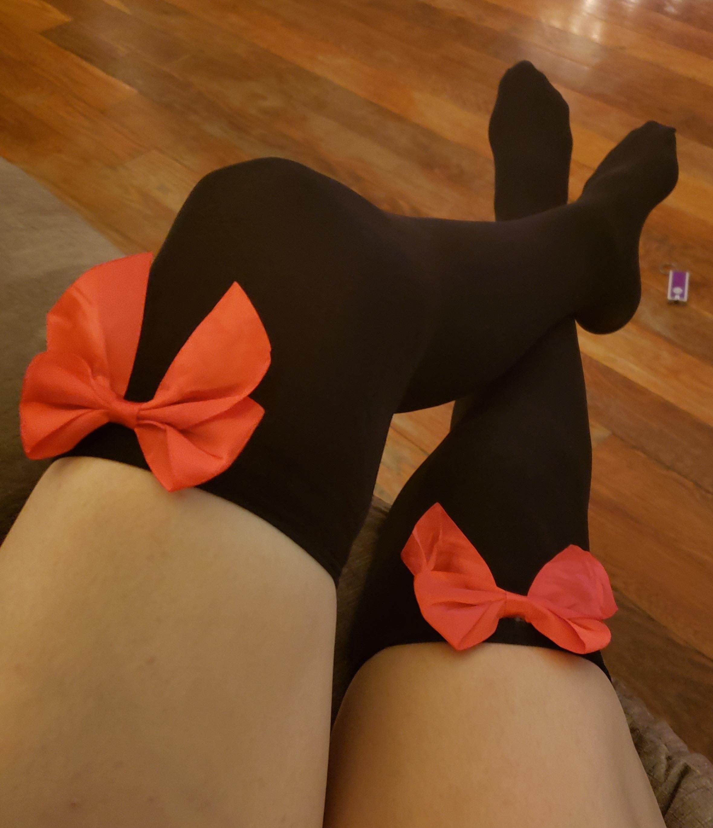 a reviewer wearing the black socks with red bows