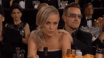 Bono giving Amy Poehler a shoulder massage at the Golden Globes.