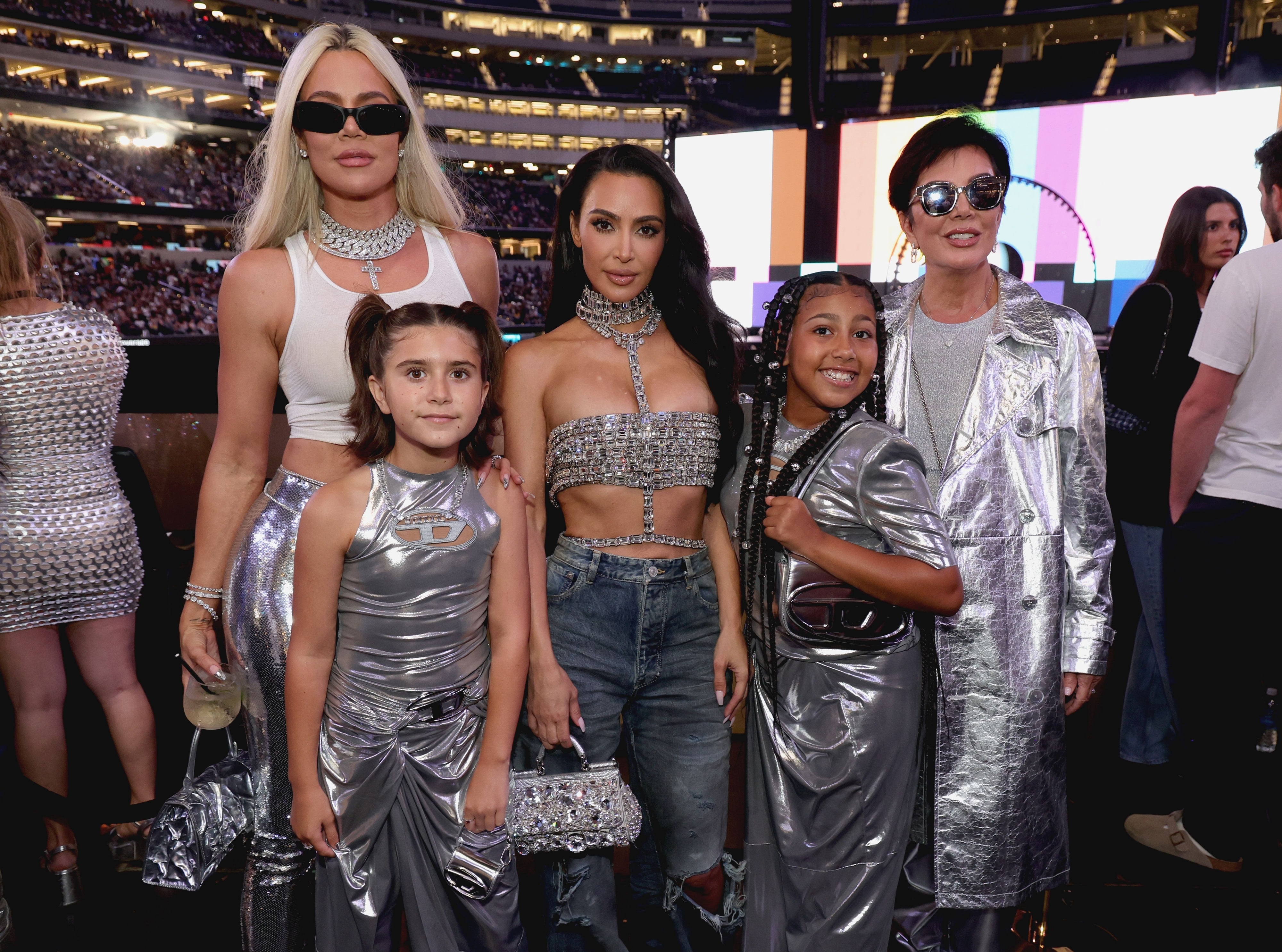 Khloé, Kim, North, and Kris Jenner with Kourtney&#x27;s daughter Penelope in silver outfits